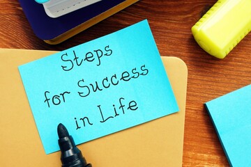 Motivation concept meaning Steps for Success in Life with sign on the sheet.