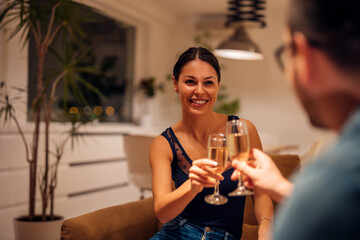 Couple toasting with a glass of champagne, portrait.