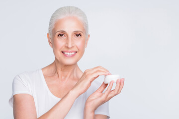 Close up photo of charming lady holding jar with nourishing gel want to apply wearing white trendy...