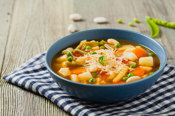 Minestrone soup with pasta and cheese.