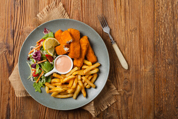 Fish sticks with fries and salad.