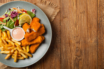Fish sticks with fries and salad.