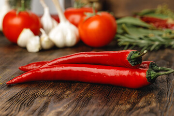 Garlic and chili pepper on dark wooden table