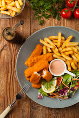 Fish sticks with fries and salad.