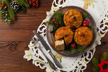 Small, baked patties in Christmas retro styling. Top view. Natural wooden background.