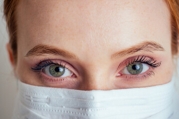 virologist woman in chemical protection mask ,glasses and gloves holding potential vaccine at the lab