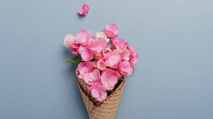Ice cream cone with pink begonia flowers