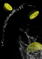Fototapeta na wymiar flying pieces of lemon fall into a glass and make a splash.