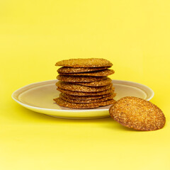 Homemade freshly baked sesame cookies on a yellow background. Keto gluten-free pastries.