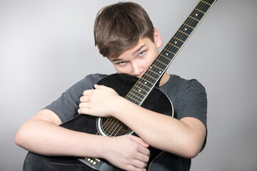 Teenager with guitar, young musician
