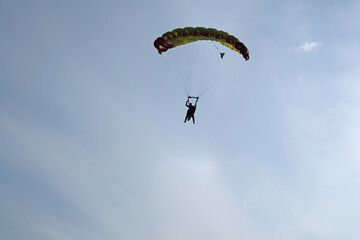 A parachute is in the sky.