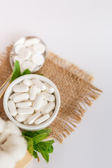 Nutrition supplements and meds in rustic style on a white background. Vitamins for good health.