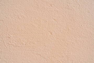Fototapeta premium Pink stucco texture. Architectural abstract background. Pink wall of building.