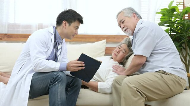 Asian elder couple are meeting doctor at home.