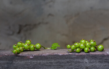 Green currants on old wooden
