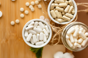 Herbal nutrition supplements and vitamins on brown background. Healthy lifestyle and care about immunity.