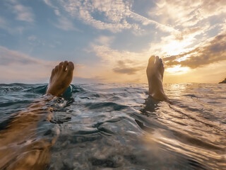 Feet above the water during sunset