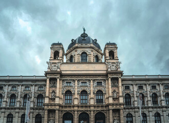 Fototapeta na wymiar Hoffburg Imperial Palace in Vienna, Austria. Luxurious baroque facade and gloomy rainy sky