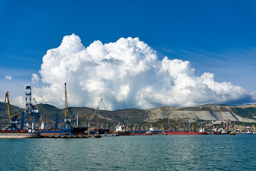 Clouds over mountains and port