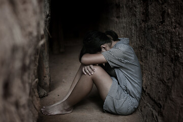 Human trafficking concept.Young girl sitting in old room.Women who are victims of trafficking.