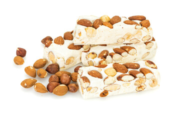 Turron blocks arranged with almonds and hazelnuts,  isolated on white background