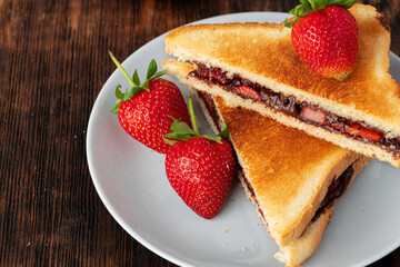 Sandwich toast with chocolate paste and cut strawberry