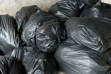 Fototapeta na wymiar Black garbage bags in the garbage dump of the village.