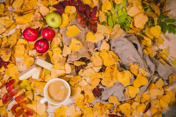 Autumn background. A cup of coffee on the autumn table.
