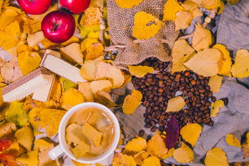 Autumn background. A cup of coffee on the autumn table.