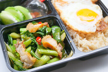Thai lunch box - Crispy pork on rice, Chinese kale and egg