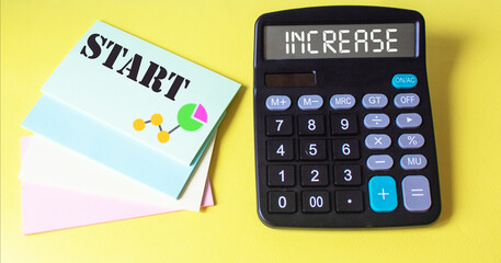 Business concept. On a yellow background, a calculator and stickers with the text Start and Increase