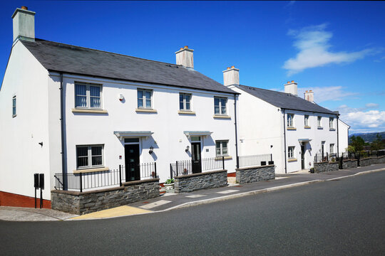 Newly built semi detached houses on an empty street in Wales, UK - housing development concept.
