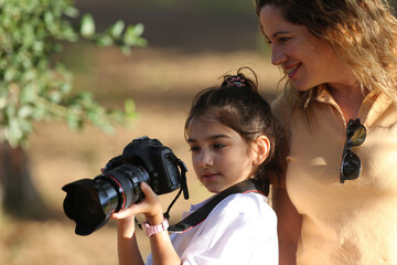 mother and daughter with a camera