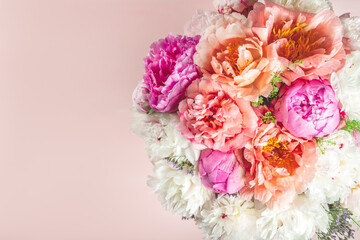 Abundance of Fresh bunch of Peonies Bouquet of different pink colors on light background. Card Concept, copy space for text