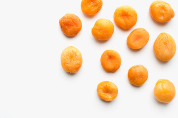 dried apricots on a white background, dried fruits - obrazy, fototapety, plakaty