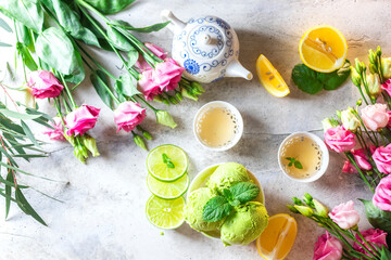 Green tea ice cream with lemon on a gray stone background.