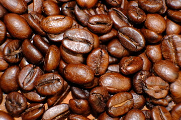 Blurred coffee beans on wood table and macro coffee beans background