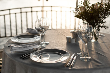 Table set at restaurant on light background for a wedding, romantic dinner or celebration