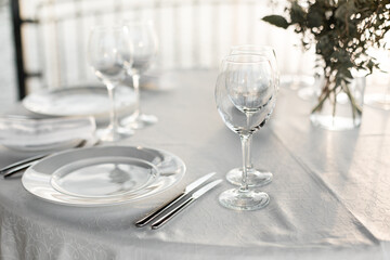 Table set at restaurant on light background for a wedding, romantic dinner or celebration
