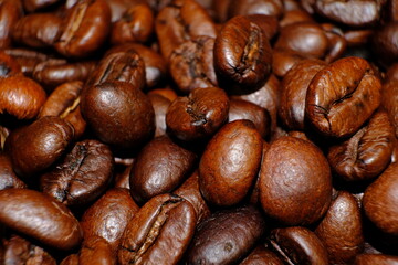 Blurred coffee beans on wood table and macro coffee beans background