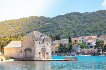 Small picturesque house of Saint Jerolim, stone greek style building standing on the waterfront of Starigrad,Hvar.