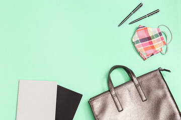 School bag and school supplies, notebooks, pens, mask for protection from infections on neo mint...