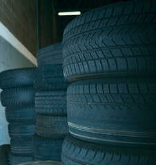 Old used car tires stacked on top of each other. Selective focus. Closeup view.