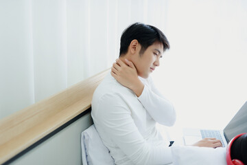 Health concept of Asian male neck pain in bed