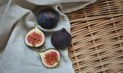 Fresh figs on a towel on a wicker tray