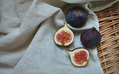 Fresh figs on a towel on a wicker tray