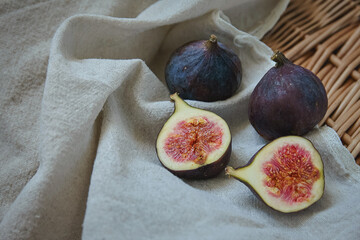 Fresh figs on a towel on a wicker tray