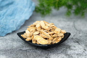 Chinese herbal medicines -- Astragalus on stone background
