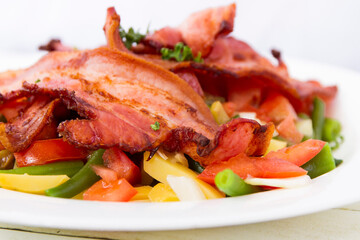Salad with bacon from the side close up