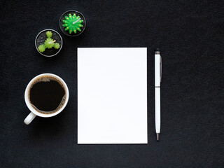 blank white paper, coffee cup, a pen and small cacti on black background. Copy space. concept of planning and studying